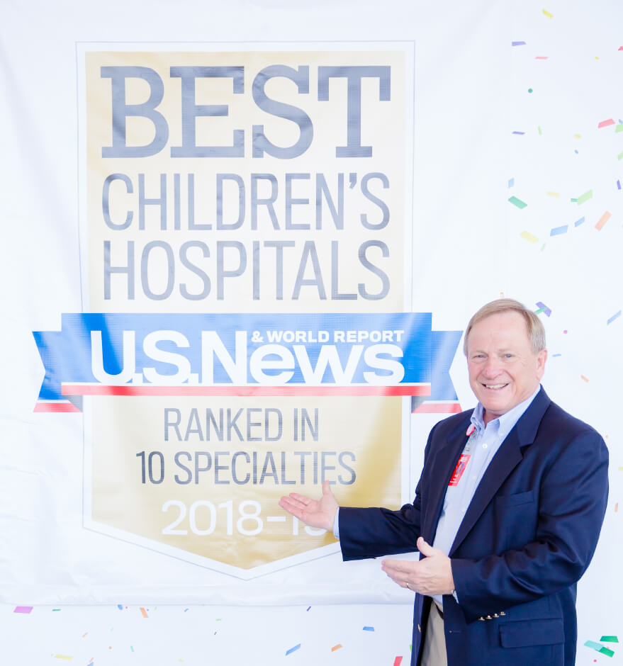 Photo of CEO in front of Best Children's Hospital US News Sign