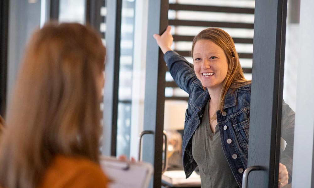 Two women talking about the digital journey in an office.